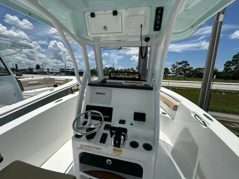 Slide: The Image of 2026 Sea Pro 262 Center Console boat interior with steering wheel and control panel. - 4