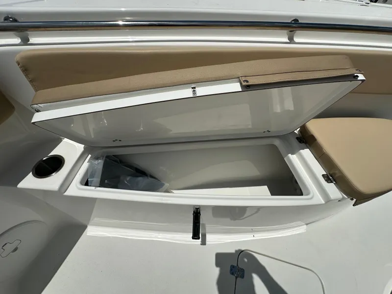 Slide: The Image of Open storage compartment on 2026 Sea Pro 262 Center Console boat with beige seating. - 7