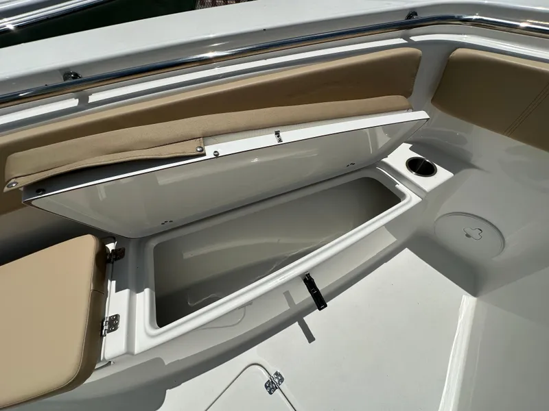 Slide: The Image of Open storage compartment on 2026 Sea Pro 262 Center Console boat with beige seating. - 8
