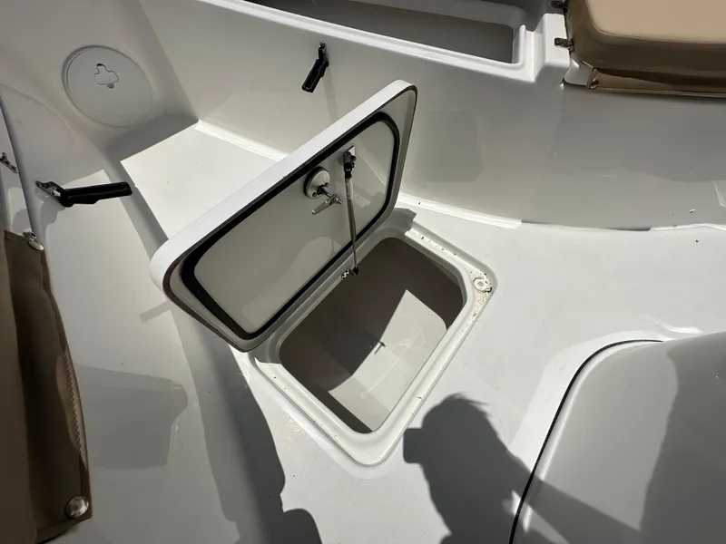 Slide: The Image of Open storage compartment on 2026 Sea Pro 262 Center Console boat deck. - 9