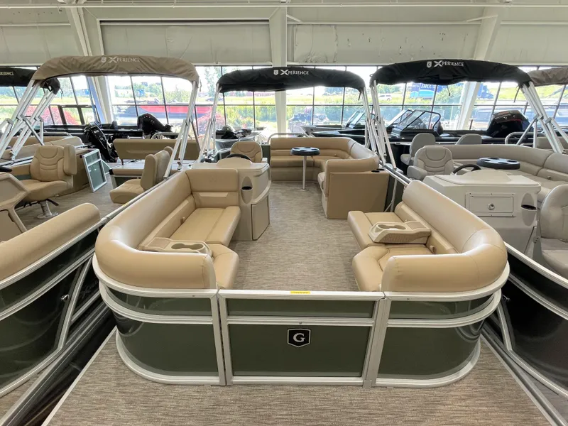 The Image of 2026 Godfrey Xperience 2086 CX pontoon boat with beige seating in showroom. - 0
