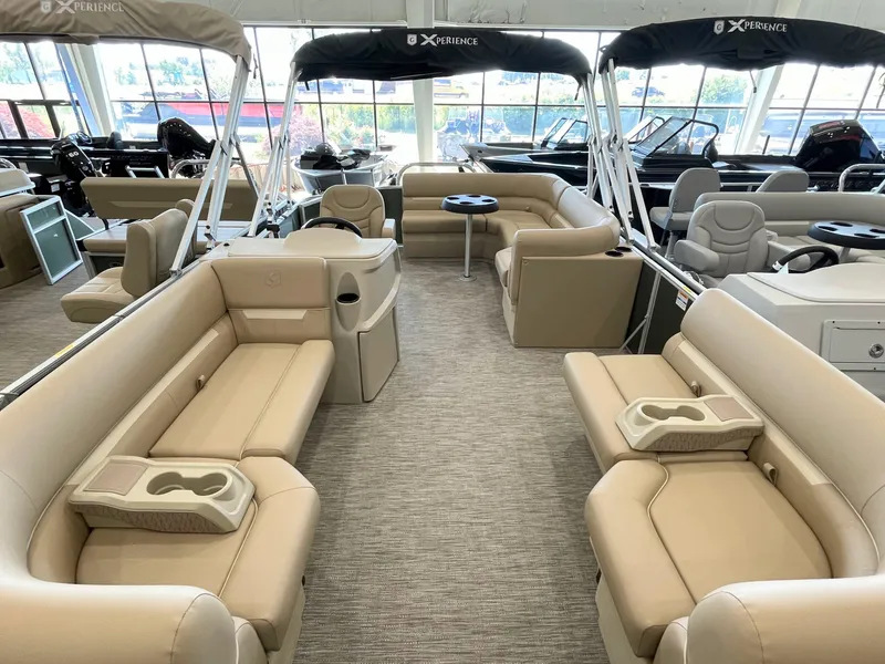 Slide: The Image of Interior of 2026 Godfrey Xperience 2086 CX pontoon boat with beige seating and cup holders. - 2