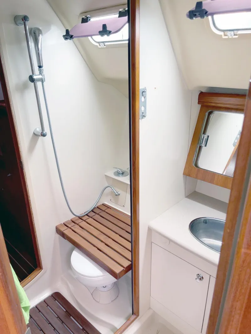 Slide: The Image of Compact bathroom in a 2005 Hunter 38 sailboat with shower, toilet, and sink. - 11