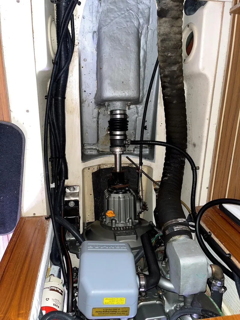 Slide: The Image of Engine compartment of a 2005 Hunter 38 sailboat, showing mechanical components and wiring. - 13