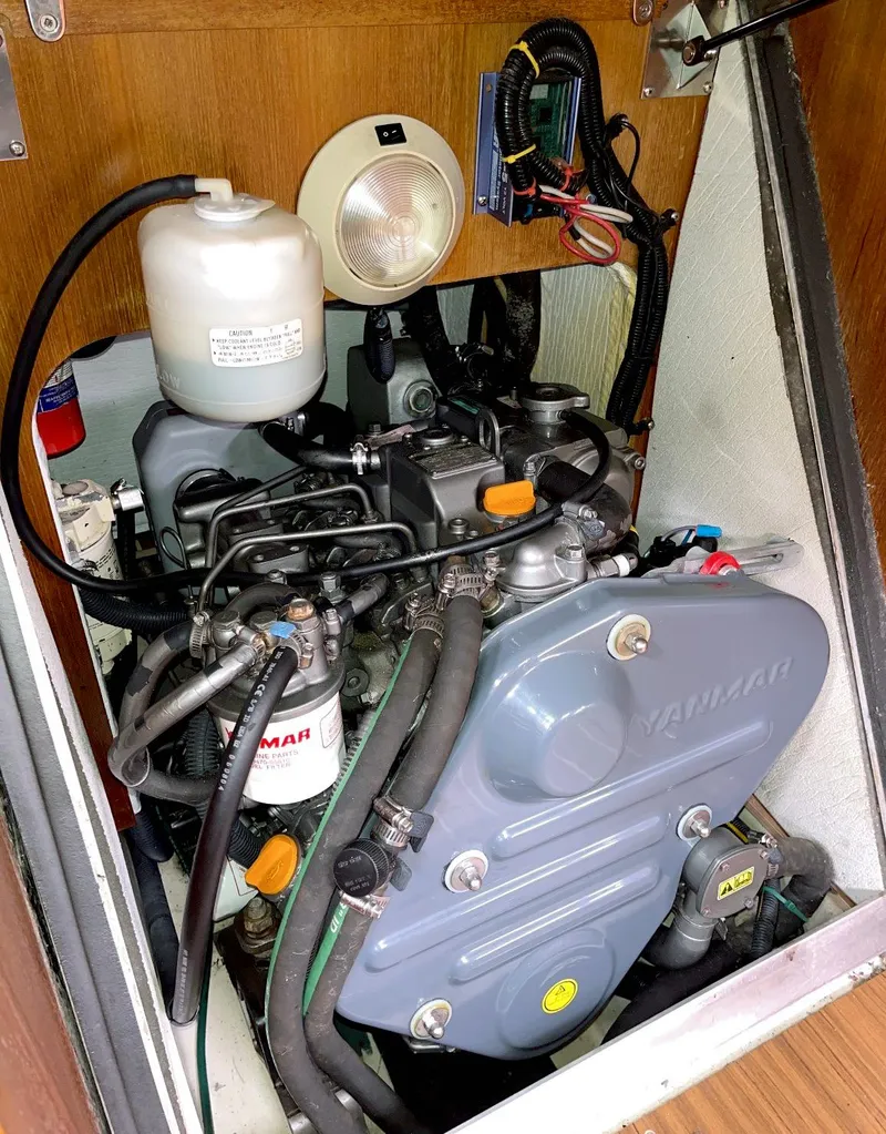 Slide: The Image of Engine compartment of a 2005 Hunter 38 sailboat featuring a Yanmar engine. - 14