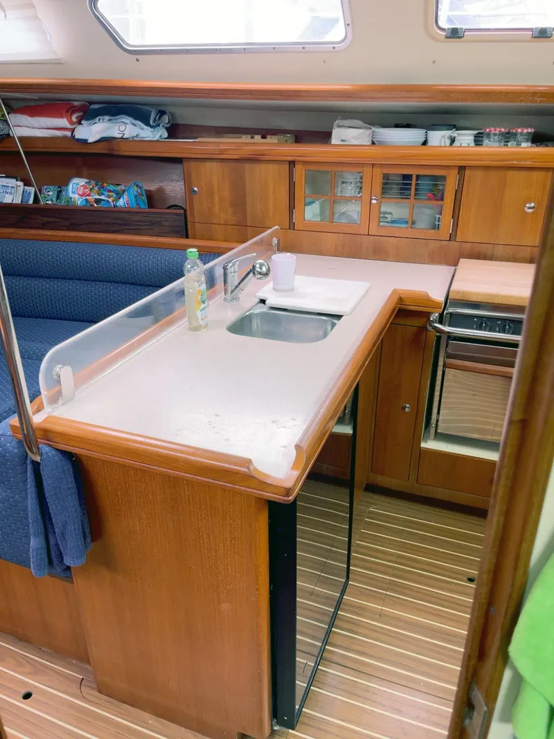 Slide: The Image of Interior of 2005 Hunter 38 sailboat kitchen with wooden cabinetry and compact design. - 5