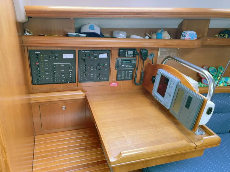 Slide: The Image of Navigation station of a 2005 Hunter 38 sailboat with control panels and equipment. - 6