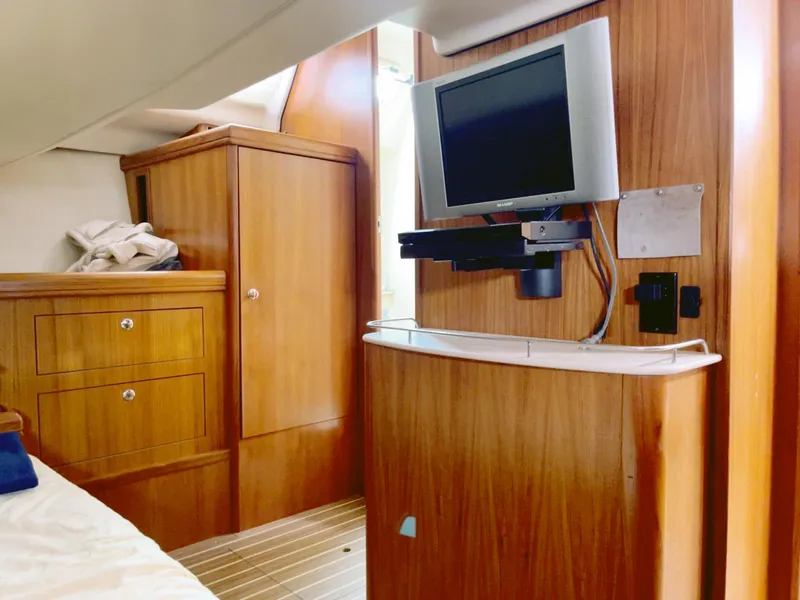 Slide: The Image of Interior of 2005 Hunter 38 yacht with wood cabinetry and mounted TV. - 8