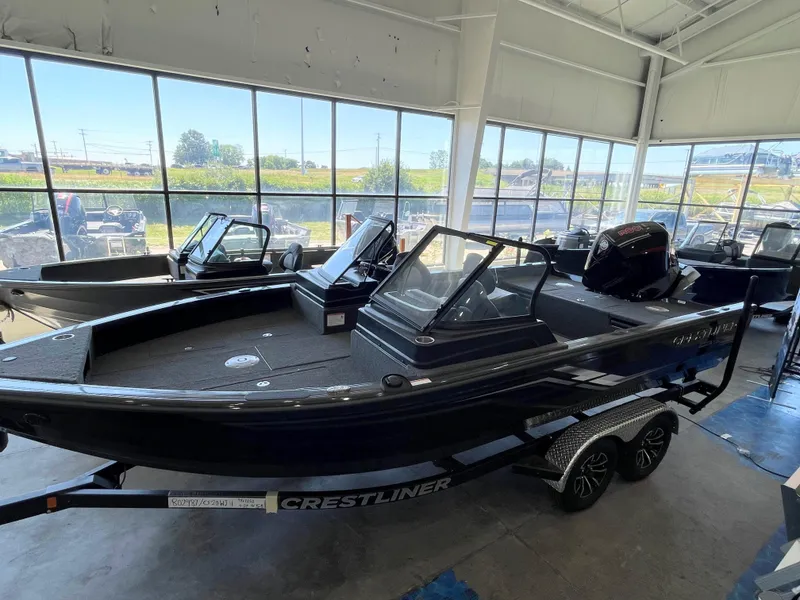The Image of 2025 Crestliner 2050 Fish Hawk boat displayed in a showroom, featuring sleek design and modern amenities. - 0