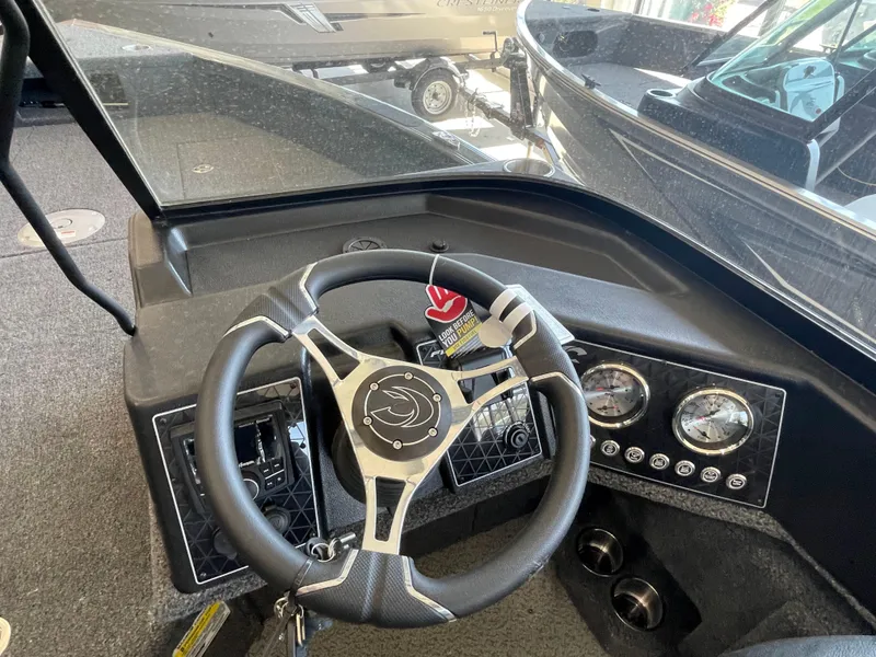 Slide: The Image of 2025 Crestliner 2050 Fish Hawk dashboard with steering wheel and gauges. - 10
