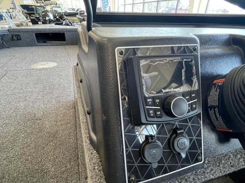 Slide: The Image of 2025 Crestliner 2050 Fish Hawk dashboard with Rockford Fosgate audio system and 12V outlets. - 11