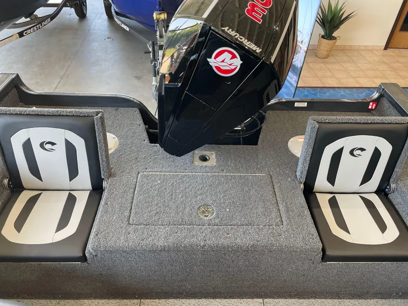 Slide: The Image of 2025 Crestliner 2050 Fish Hawk boat interior with Mercury engine and cushioned seats. - 5