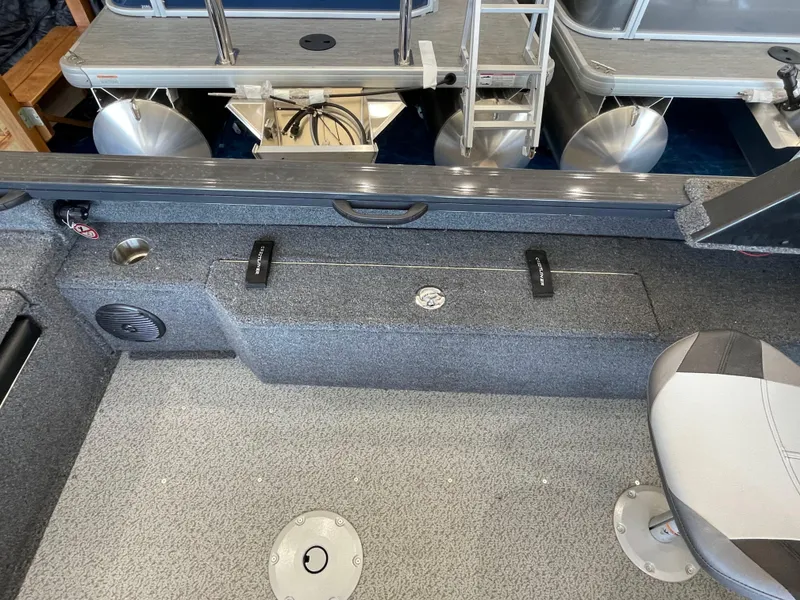 Slide: The Image of 2025 Crestliner 2050 Fish Hawk interior with seating and storage compartments. - 7