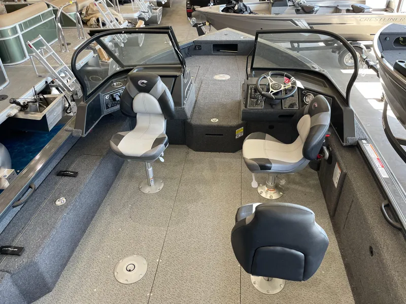 Slide: The Image of 2025 Crestliner 2050 Fish Hawk interior with seating and steering console. - 8