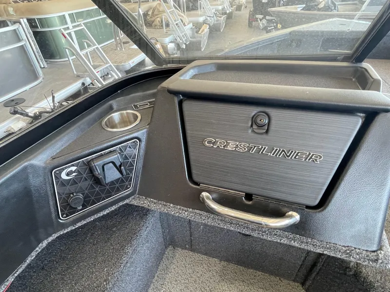 Slide: The Image of 2025 Crestliner 2050 Fish Hawk dashboard with storage compartment and cup holder. - 9