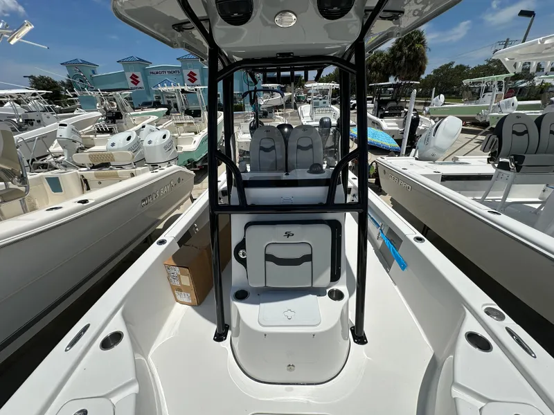 Slide: The Image of 2026 Sea Pro 230 Bay boat interior at a marina, surrounded by other boats. - 10