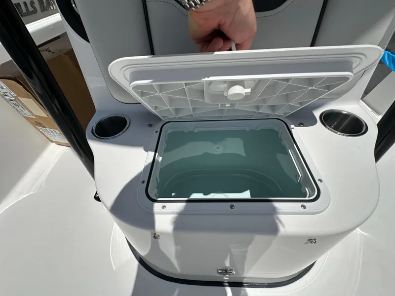 Slide: The Image of Open storage compartment on 2026 Sea Pro 230 Bay boat with cup holders. - 11