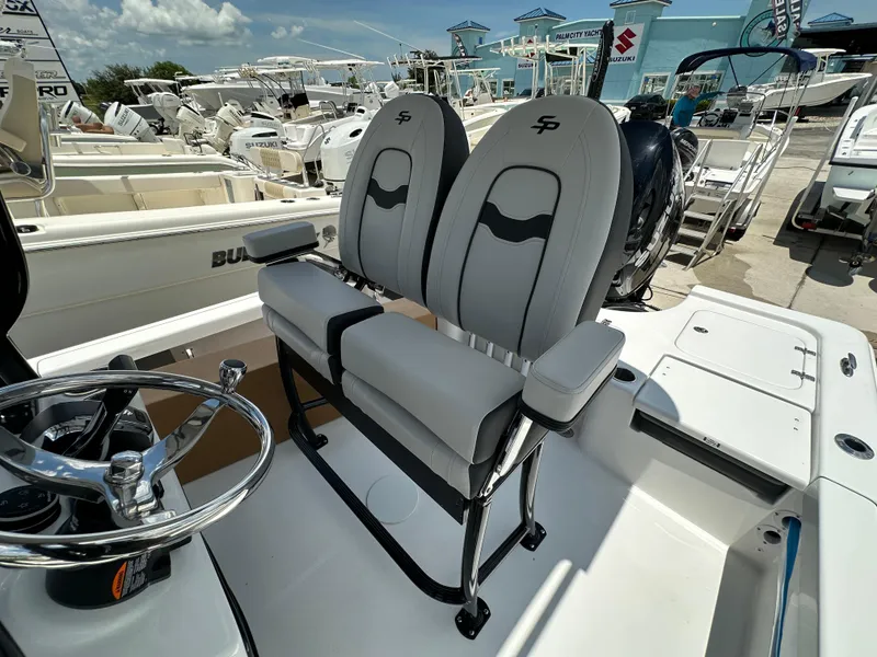 Slide: The Image of 2026 Sea Pro 230 Bay boat interior with dual seats and steering wheel. - 13