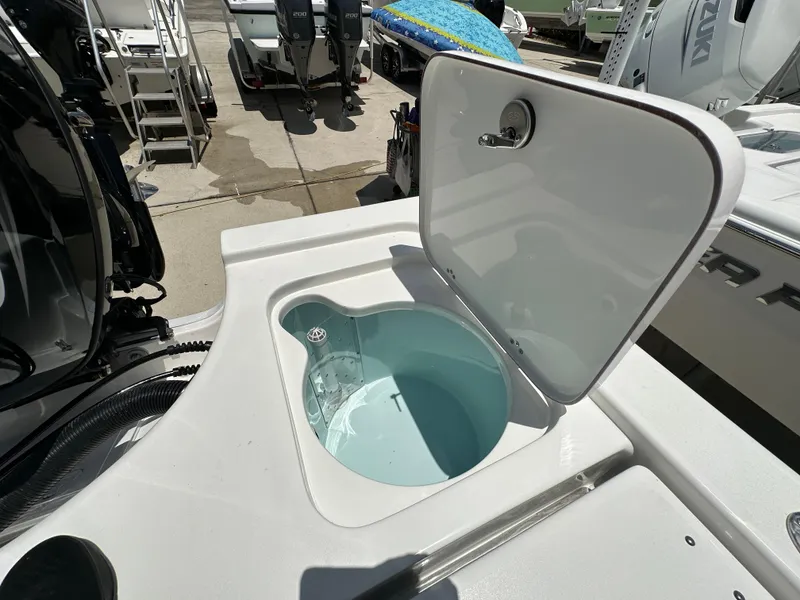 Slide: The Image of Open hatch on 2026 Sea Pro 230 Bay boat, revealing storage compartment. - 15