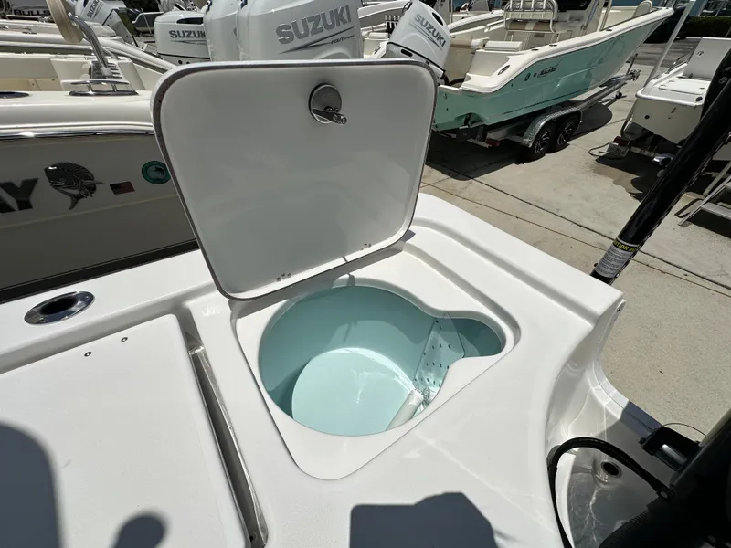 Slide: The Image of Open hatch on 2026 Sea Pro 230 Bay boat, revealing storage compartment. - 16