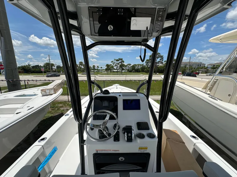 Slide: The Image of 2026 Sea Pro 230 Bay boat interior with steering console and navigation equipment. - 4