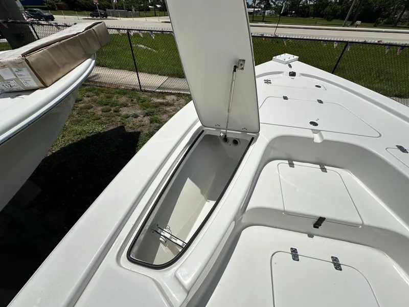 Slide: The Image of 2026 Sea Pro 230 Bay boat with open storage compartment on deck. - 6