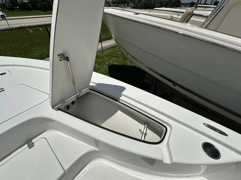Slide: The Image of 2026 Sea Pro 230 Bay boat with open storage compartment on deck. - 8
