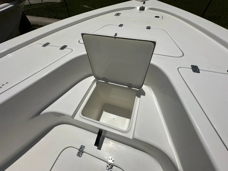 Slide: The Image of 2026 Sea Pro 230 Bay boat deck with open storage compartment. - 9