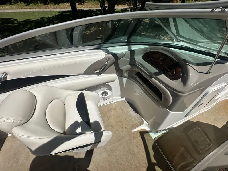 Slide: The Image of 2007 Crownline 220 LS boat interior with beige seating and dashboard details. - 23