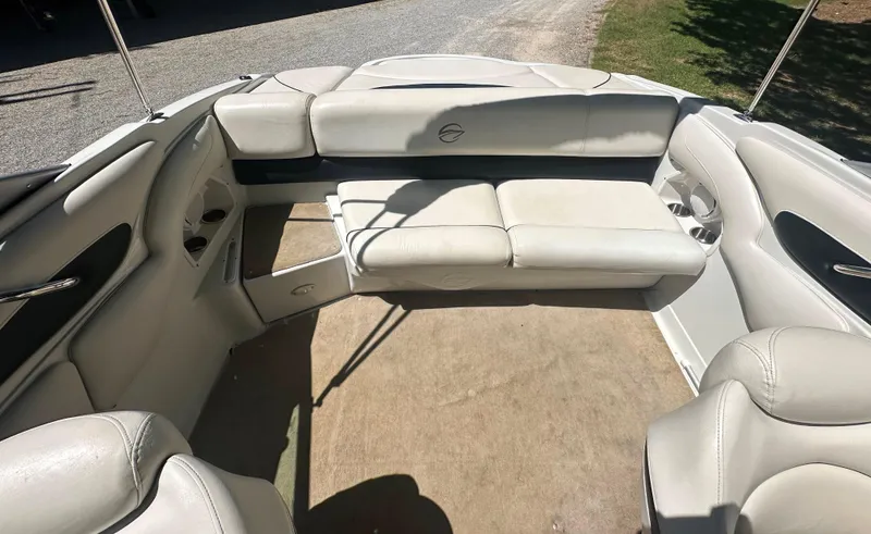 Slide: The Image of 2007 Crownline 220 LS boat interior with white seating and carpeted floor. - 24