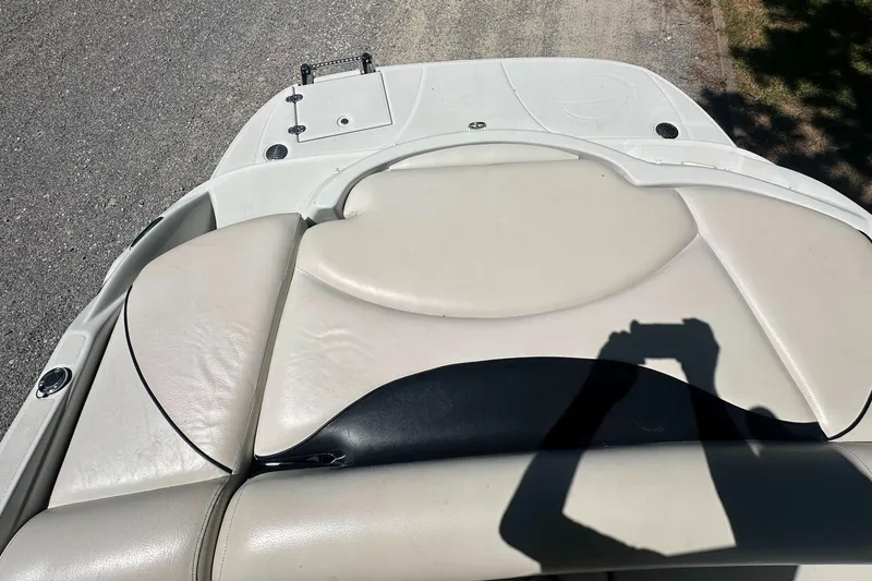 Slide: The Image of 2007 Crownline 220 LS boat interior with beige seating and shadow on deck. - 28