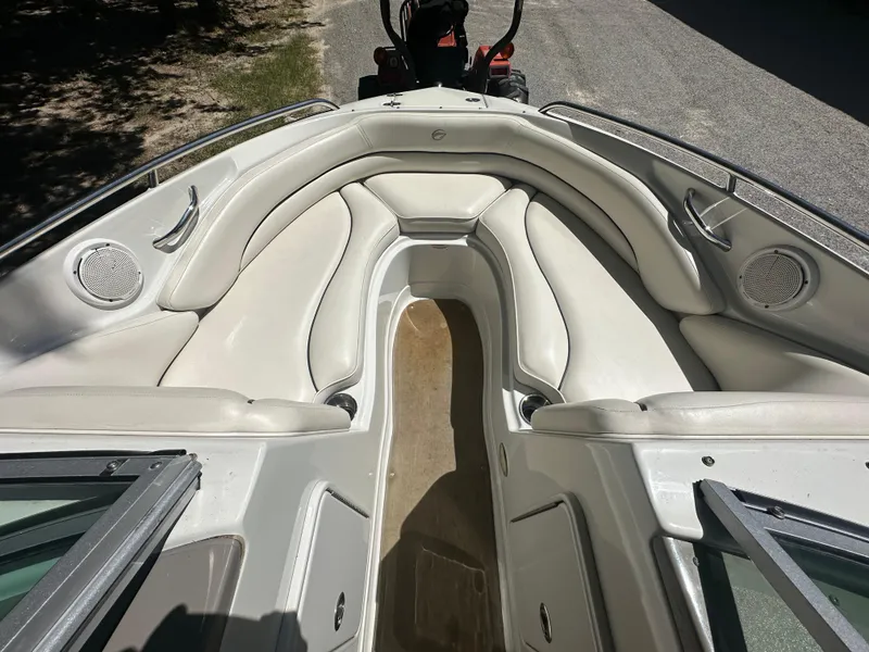 Slide: The Image of 2007 Crownline 220 LS boat interior with white seating and speakers. - 29