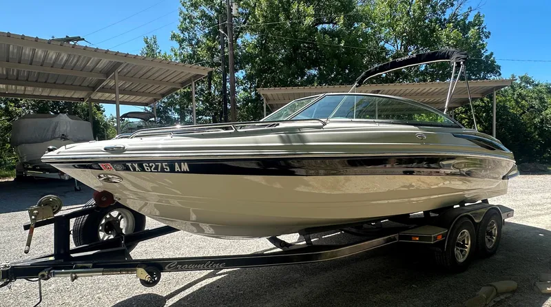 Slide: The Image of 2007 Crownline 220 LS boat on trailer, parked under a metal canopy. - 6
