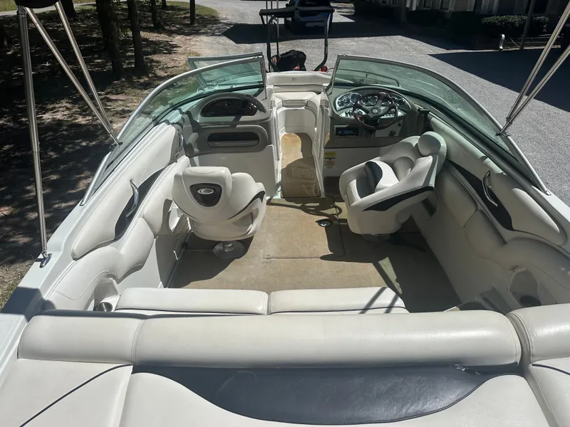 Slide: The Image of 2007 Crownline 220 LS boat interior with white seating and steering console. - 8