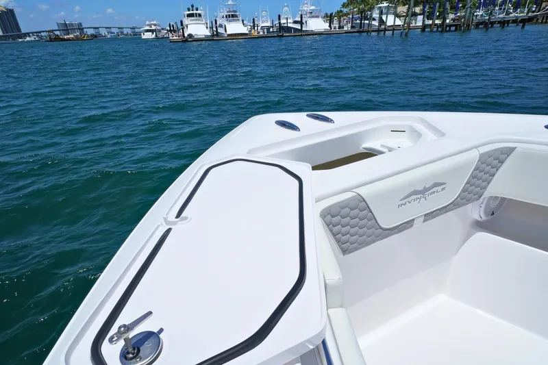 Slide: The Image of 2025 Invincible 39 Open Fisherman boat on calm blue water near marina. - 17