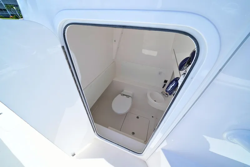 Slide: The Image of Interior view of 2025 Invincible 39 Open Fisherman boat's compact bathroom. - 19
