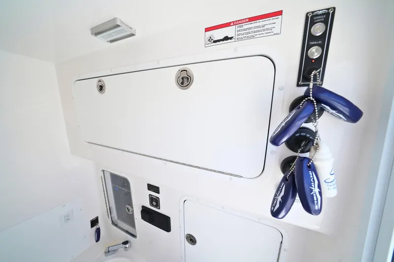 Slide: The Image of Control panel and storage on 2025 Invincible 39 Open Fisherman boat interior. - 21