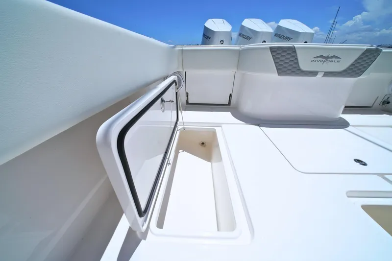 Slide: The Image of 2025 Invincible 39 Open Fisherman boat deck with storage compartment open. - 26