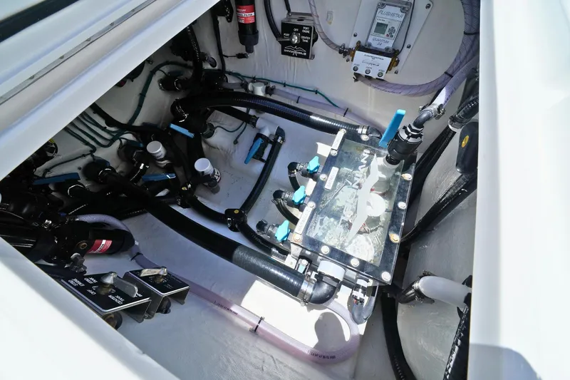 Slide: The Image of 2025 Invincible 39 Open Fisherman boat engine compartment with complex wiring and components. - 28