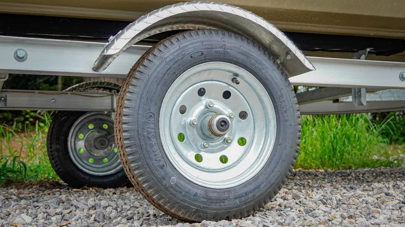 Slide: The Image of Trailer wheel of 2025 G3 1548 VBW on gravel path. - 7