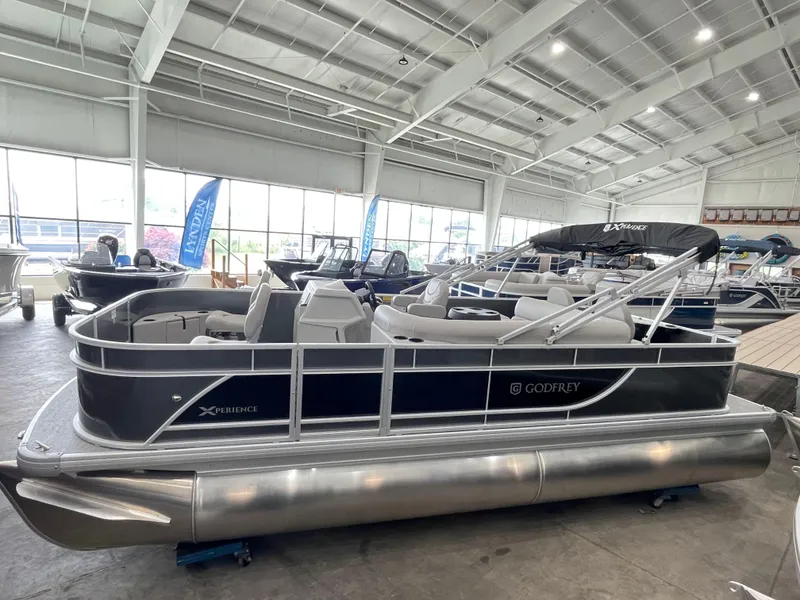 The Image of 2026 Godfrey Xperience 2086 FX pontoon boat displayed in a showroom. - 0