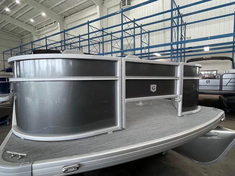 Slide: The Image of 2026 Godfrey Xperience 2086 FX pontoon boat in a showroom, showcasing sleek design. - 2