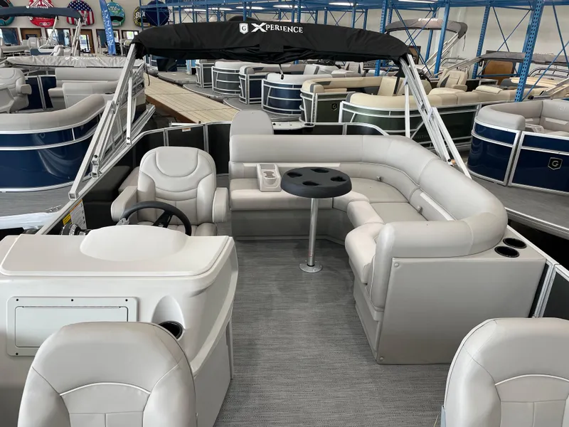 Slide: The Image of 2026 Godfrey Xperience 2086 FX pontoon boat interior with plush seating and steering console. - 3