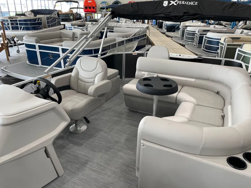 Slide: The Image of 2026 Godfrey Xperience 2086 FX pontoon boat interior with plush seating and steering console. - 6
