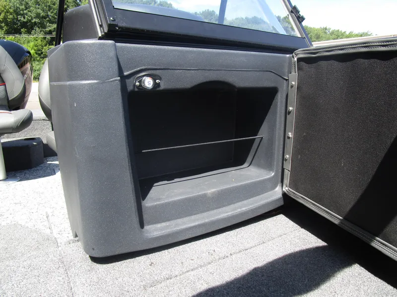 Slide: The Image of 2026 Tracker Targa V18 Combo boat interior storage compartment with open door. - 10
