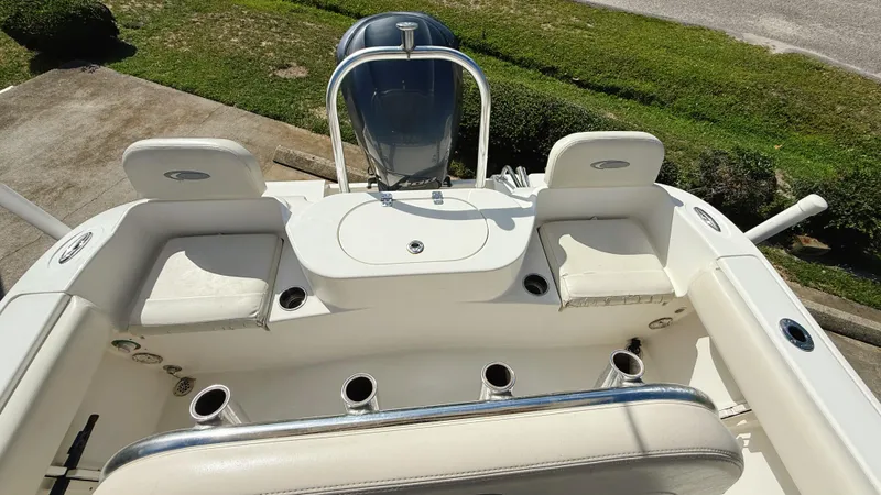 Slide: The Image of 2012 Cobia 217 Center Console boat interior with seating and rod holders. - 11