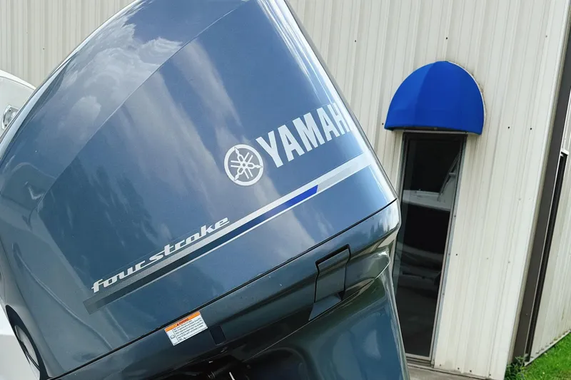 Slide: The Image of Yamaha four-stroke outboard motor on 2012 Cobia 217 Center Console boat. - 13