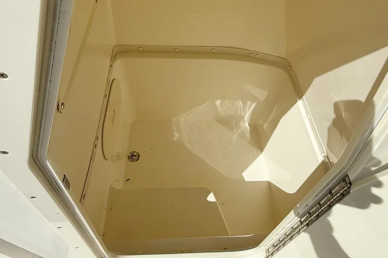 Slide: The Image of Storage compartment of 2012 Cobia 217 Center Console boat, open and empty. - 19