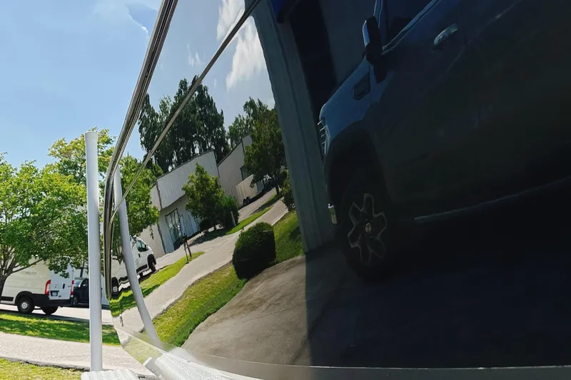 Slide: The Image of Reflection of a truck on a shiny 2012 Cobia 217 Center Console boat surface. - 4