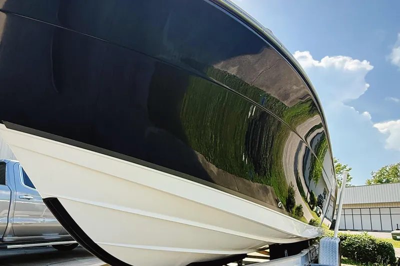 Slide: The Image of 2012 Cobia 217 Center Console boat on trailer under clear blue sky. - 5